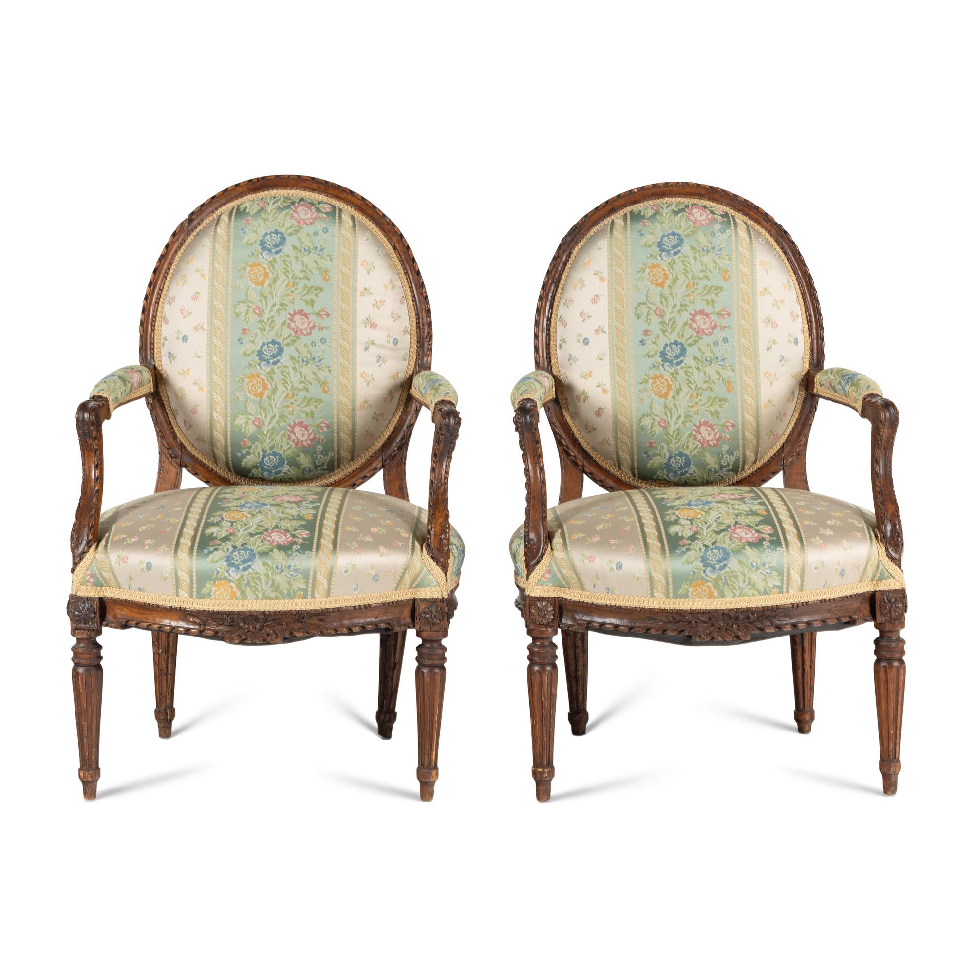 A Pair of Louis XVI Carved Walnut Fauteuils