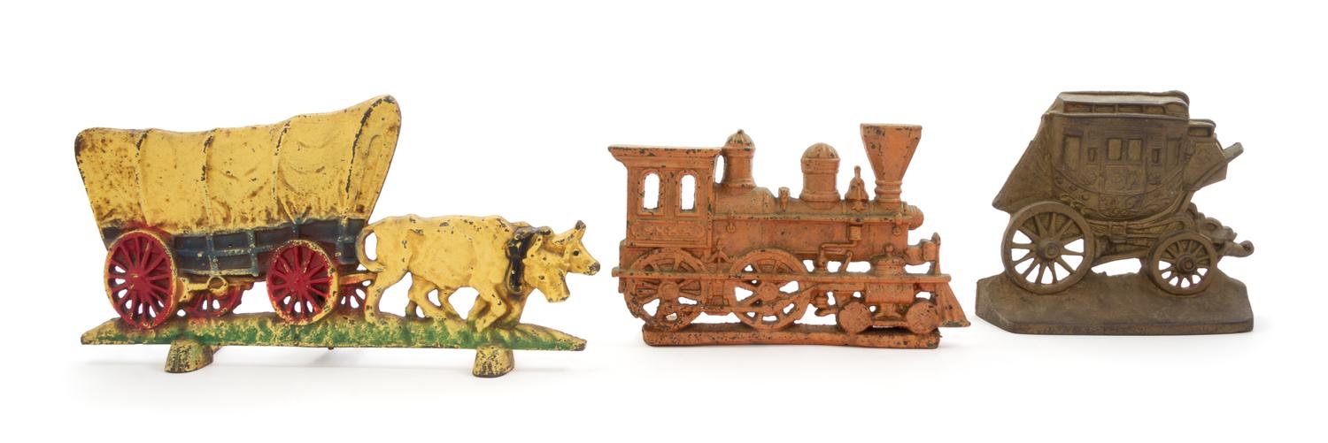 Three Cast Iron Doorstops Width of covered wagon 14 inches.