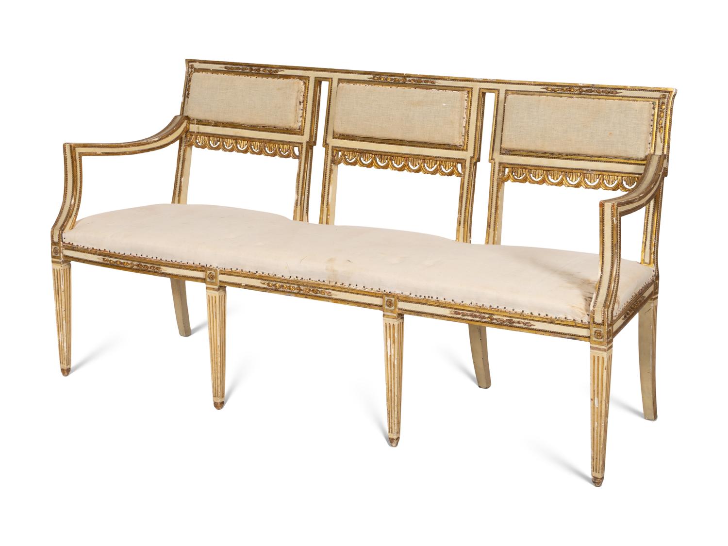 An Italian Louis XVI Style Cream Painted and Parcel Gilt Parlor Suite