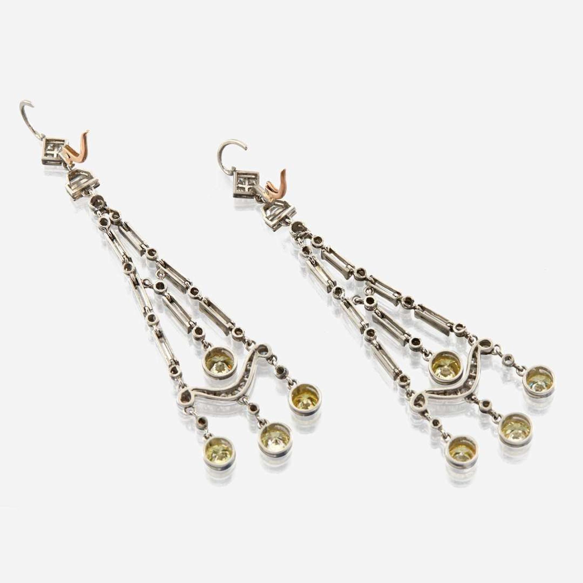 A pair of diamond, colored diamond, and platinum pendant earrings