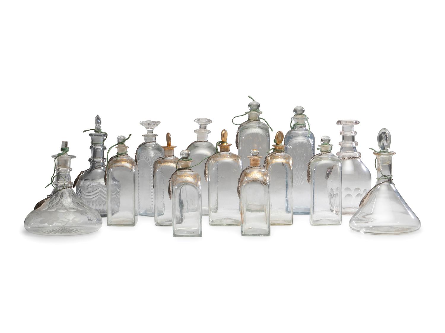 Fifteen Glass Decanters with English Shell-Form Silver Bottle Tags