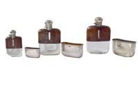 A Set of Three Silver and Stamped Leather Hip Flasks Left: 2.25" x .5" x 3.75" tall: Middle: 3" x 1" x 5" tall: Right: 3.25" x 1" x 5.5 — England, Circa 1925-1940