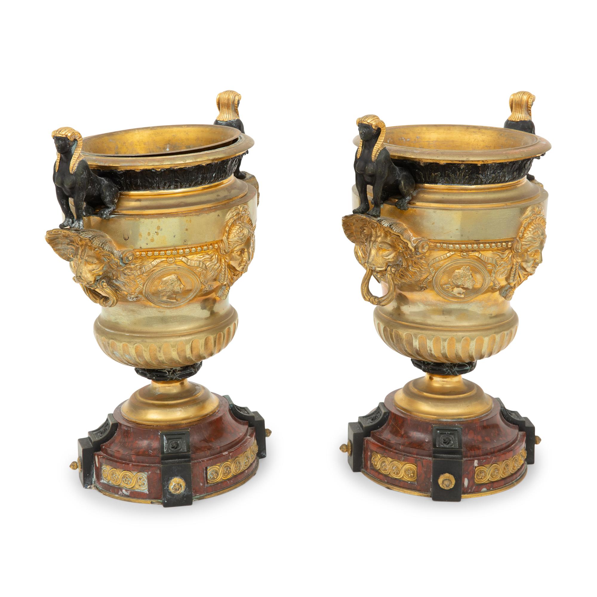 A Pair of French Egyptian Revival Gilt Bronze and Marble Urns