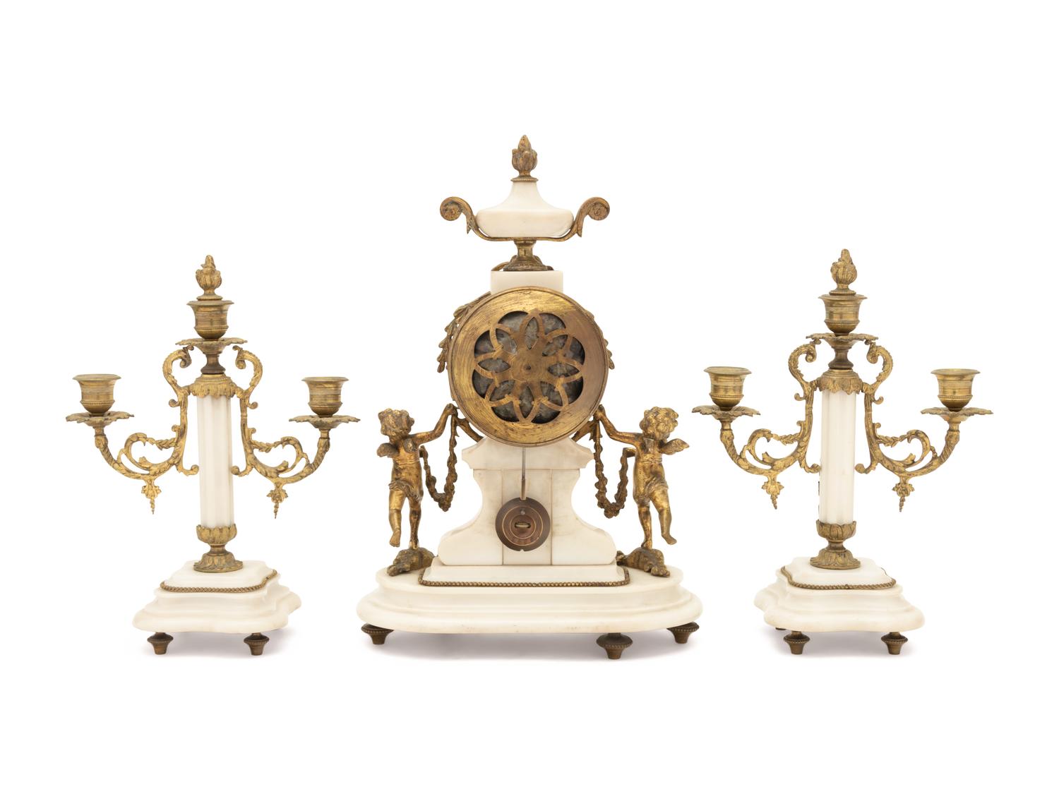 A Louis XVI Style Gilt Metal Mounted Marble Clock Garniture