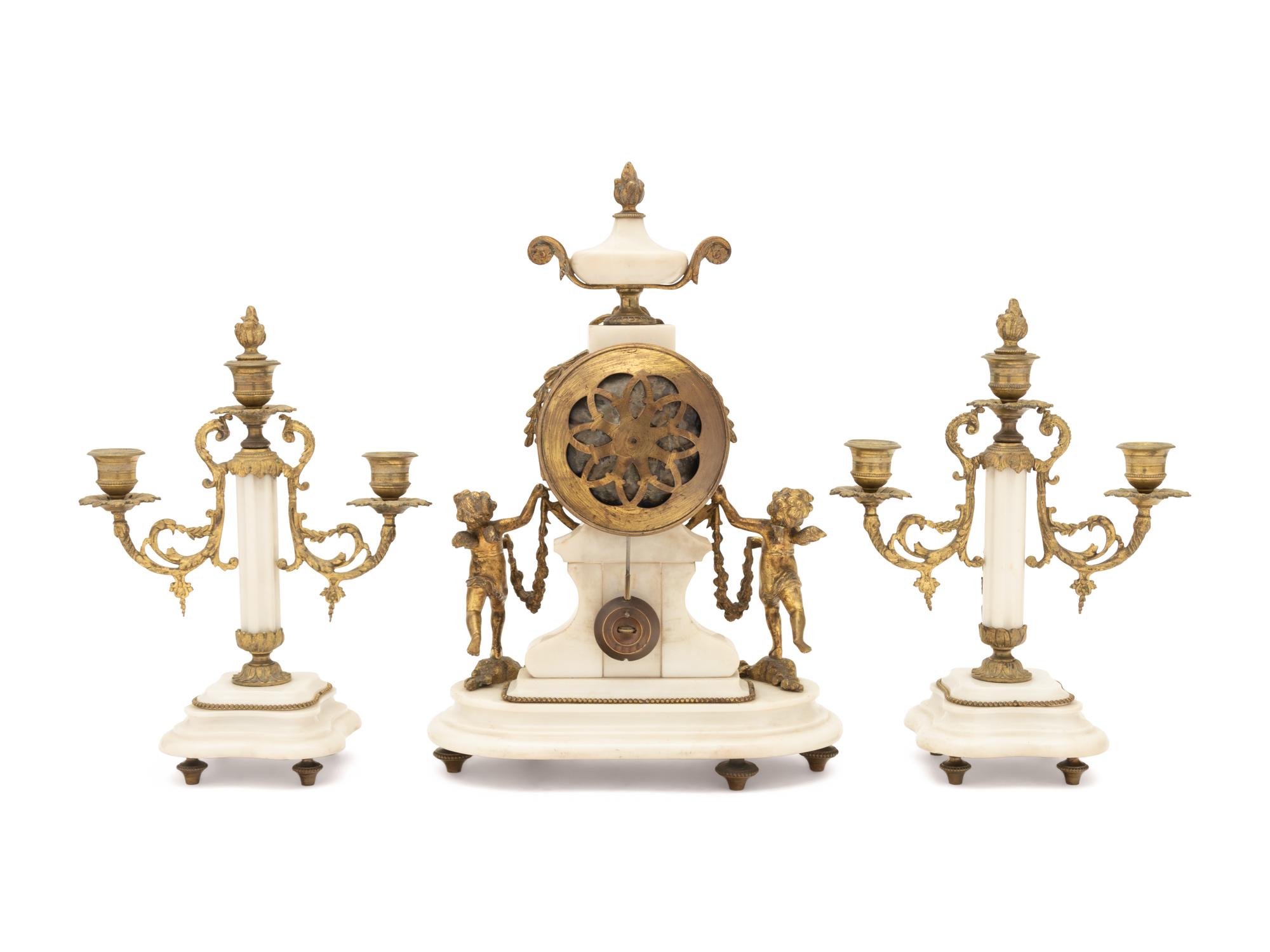 A Louis XVI Style Gilt Metal Mounted Marble Clock Garniture