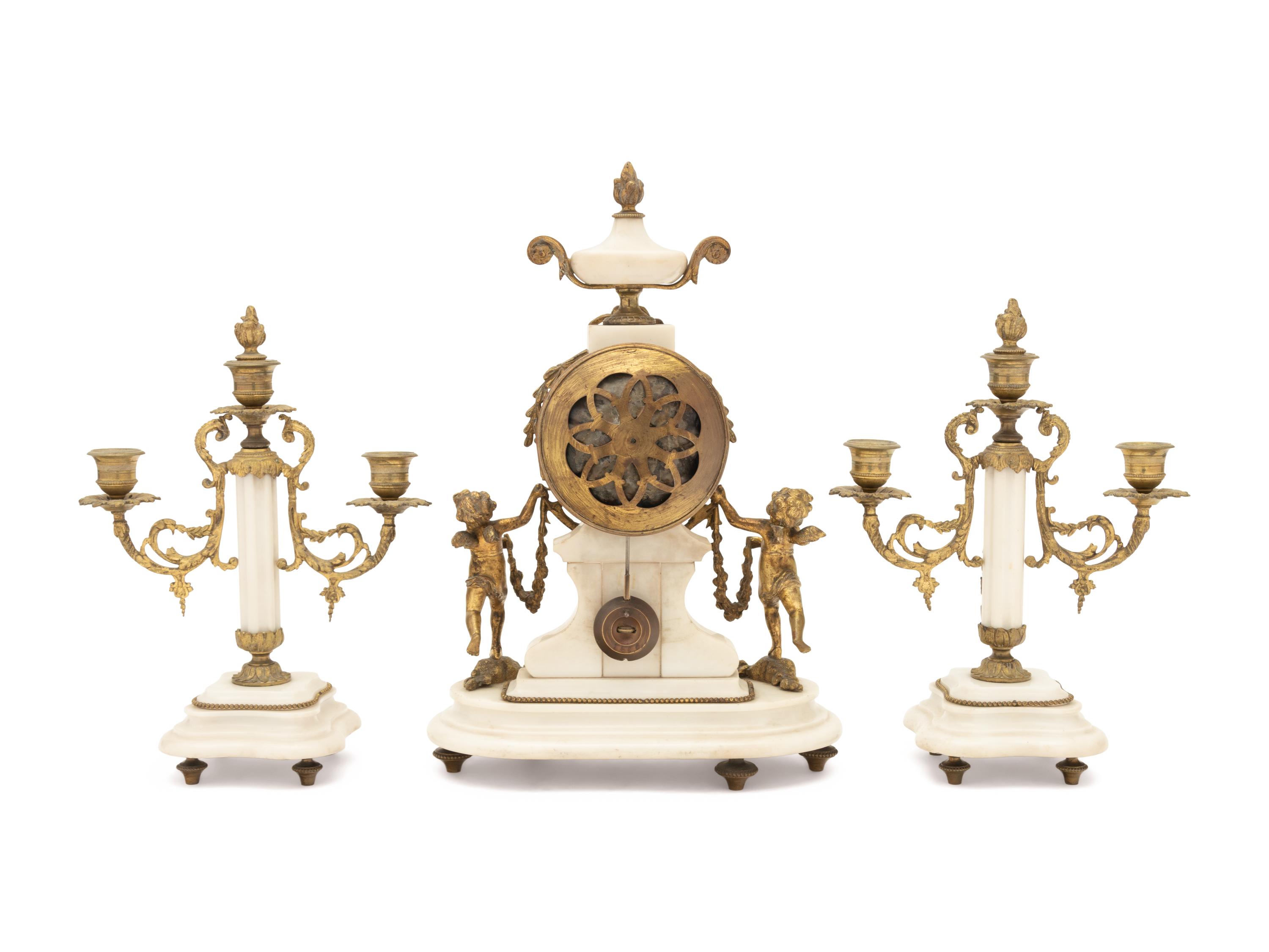A Louis XVI Style Gilt Metal Mounted Marble Clock Garniture
