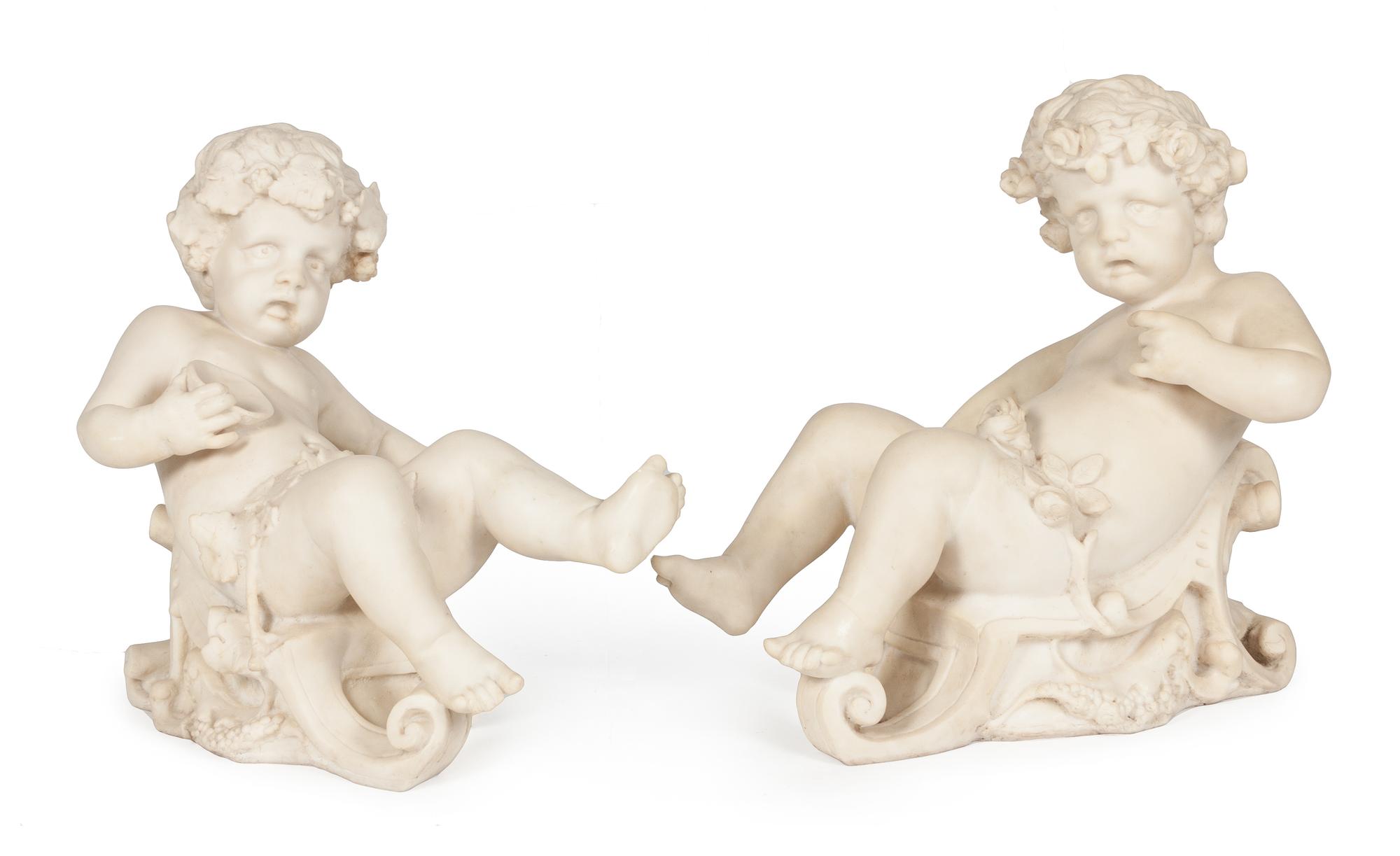 A Pair of Cast Figures of Bacchic Putti Height 21 inches.