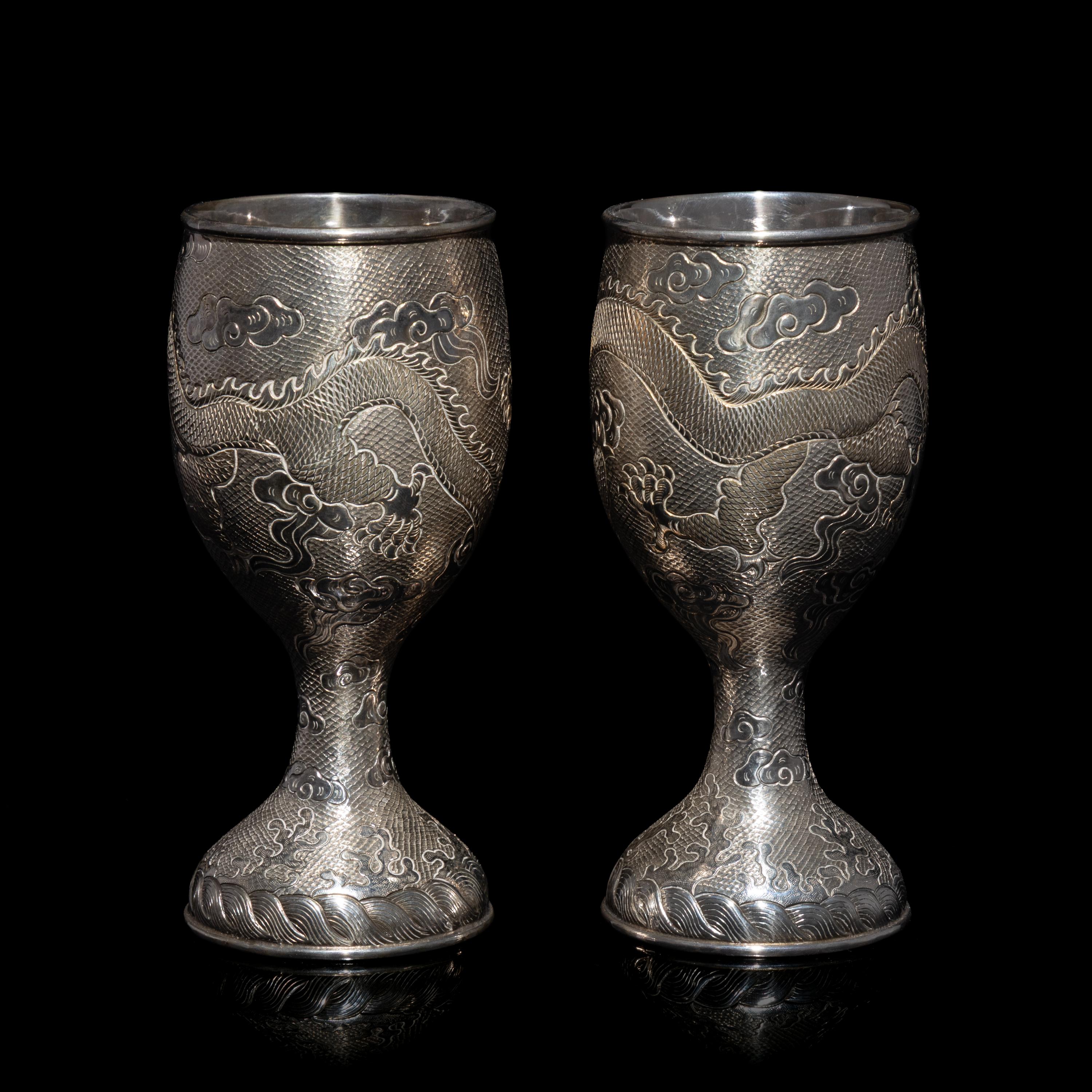 A Pair of Chinese Export Silver 'Dragon' Wine Cups, 20th Century 近代 外銷鏨云龍紋酒杯一對