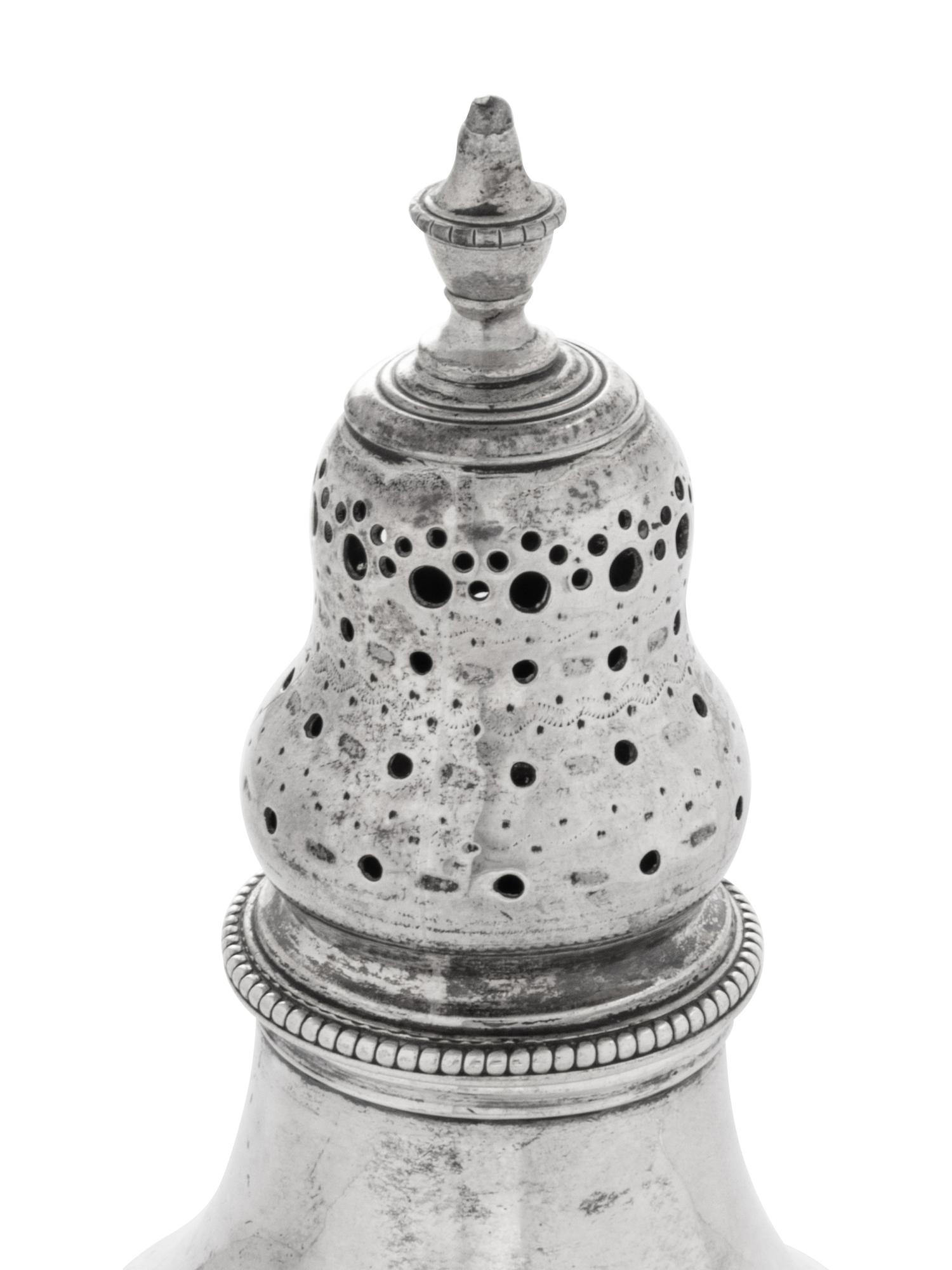 A Near Pair of George III Silver Casters