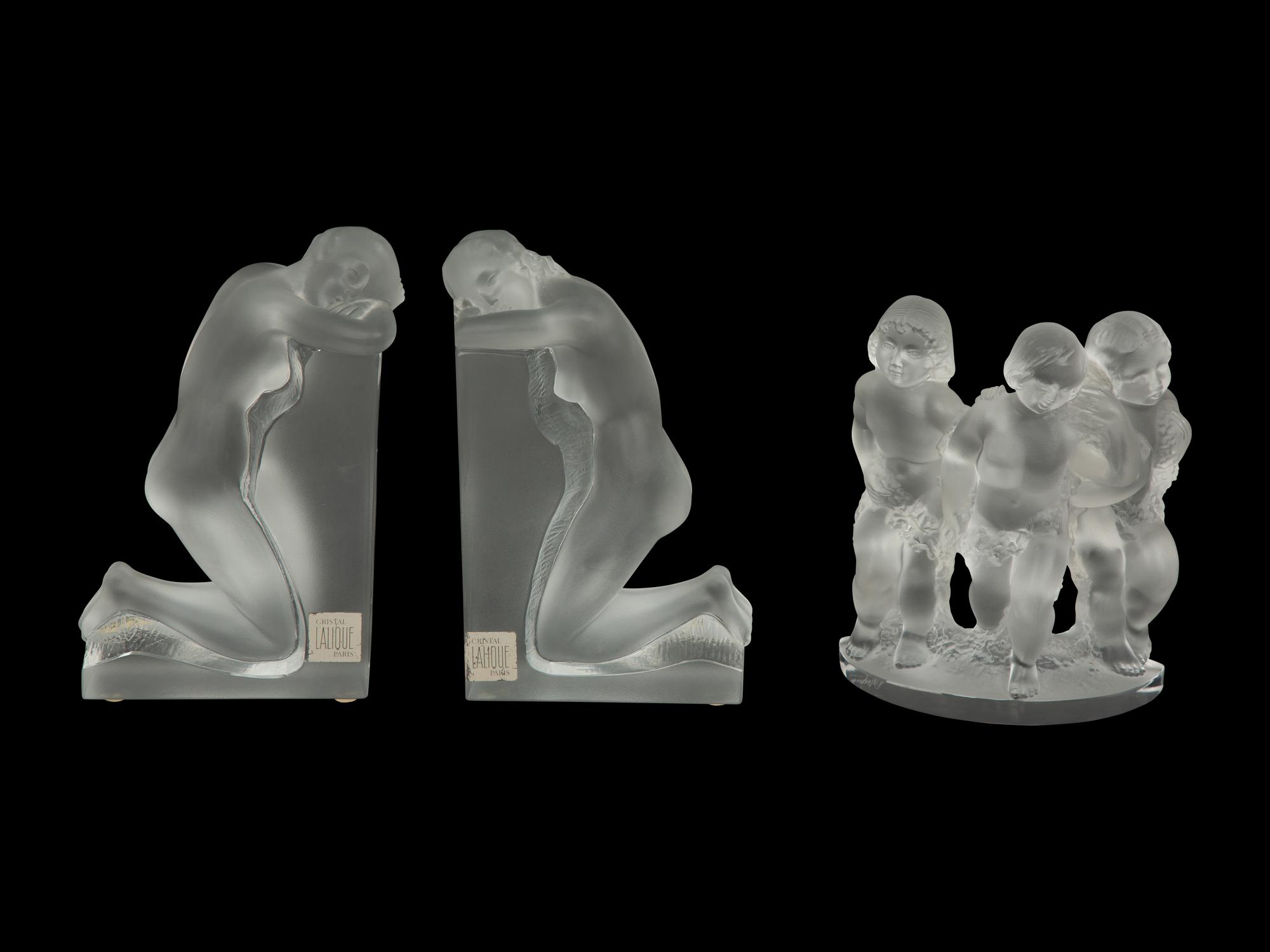 A Pair of Lalique Reverie Bookends and a Bacchantes Figural Group