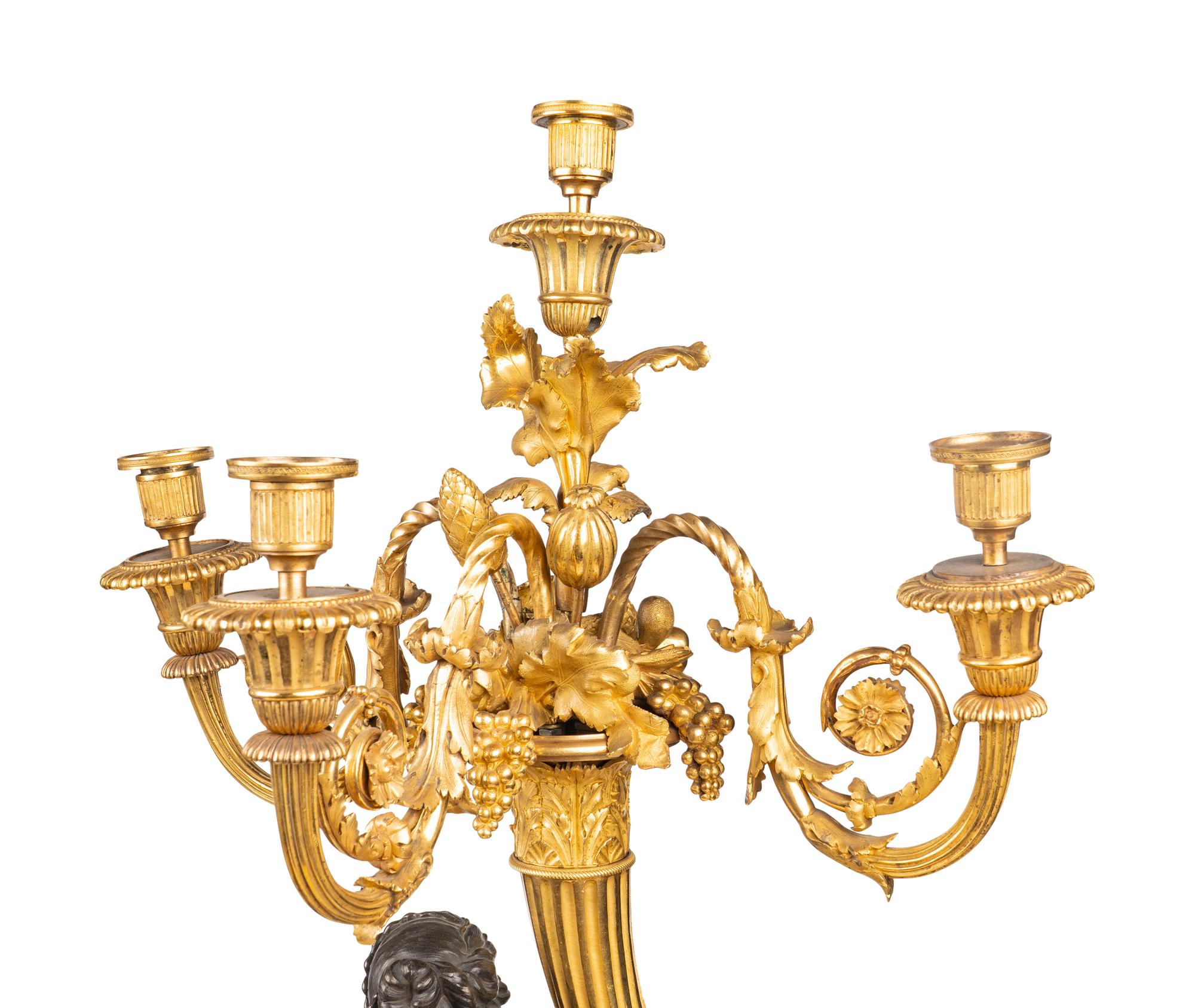 A Pair of Louis XVI Gilt and Patinated Bronze Four-Light Candelabra
