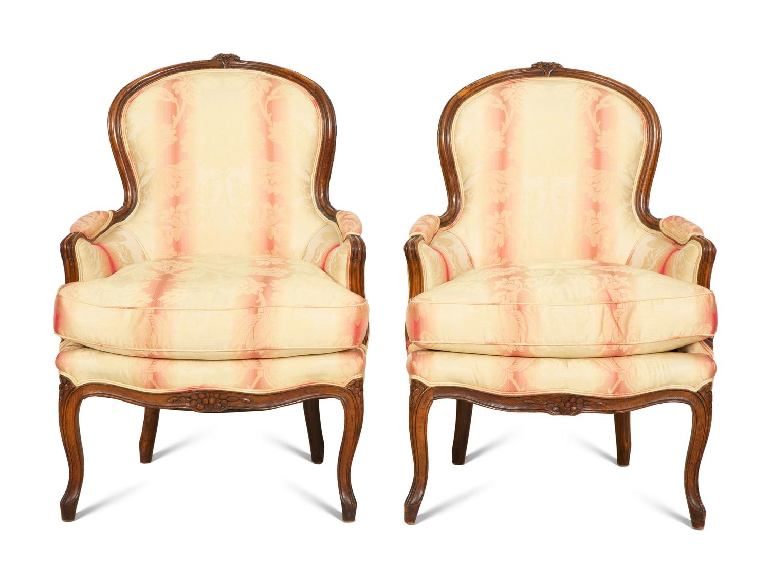 A Pair of Louis XV Style Walnut Bergères