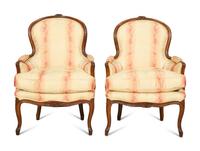 A Pair of Louis XV Style Walnut Bergères