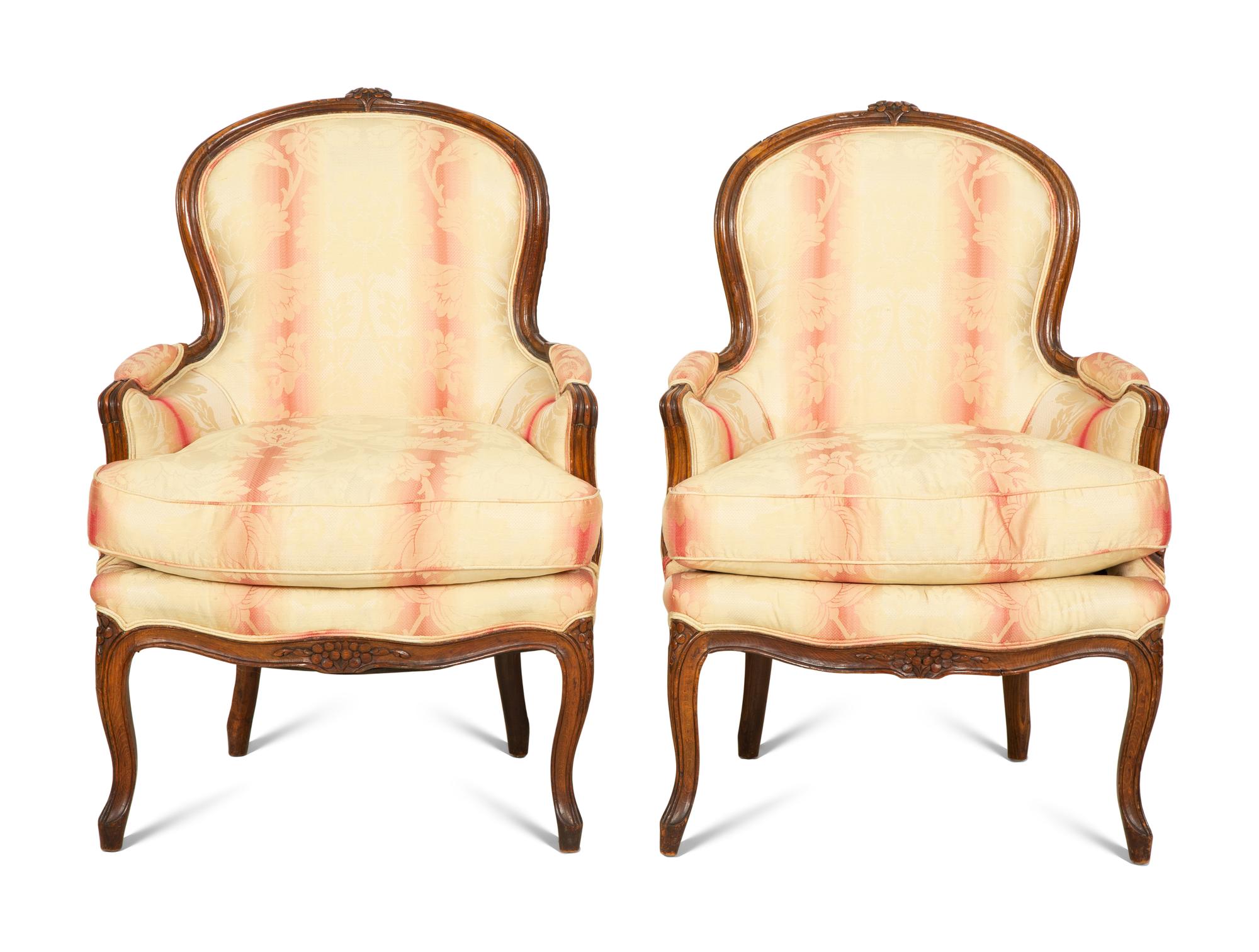 A Pair of Louis XV Style Walnut Bergères