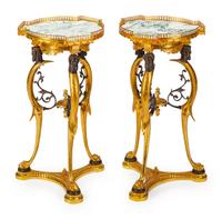 A Pair of Directoire Style Parcel-Gilt and Patinated Bronze Gueridons