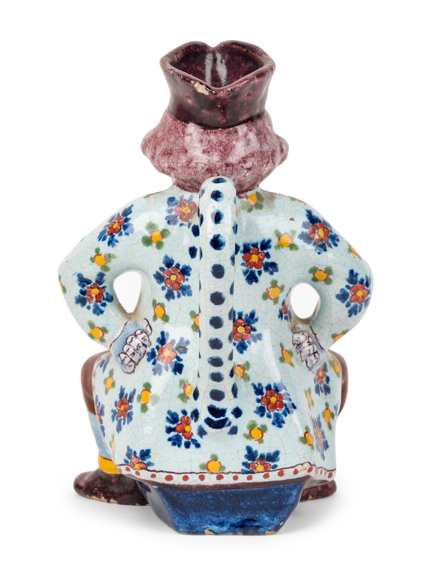 A Faïence "Man on a Barrel" Character Jug