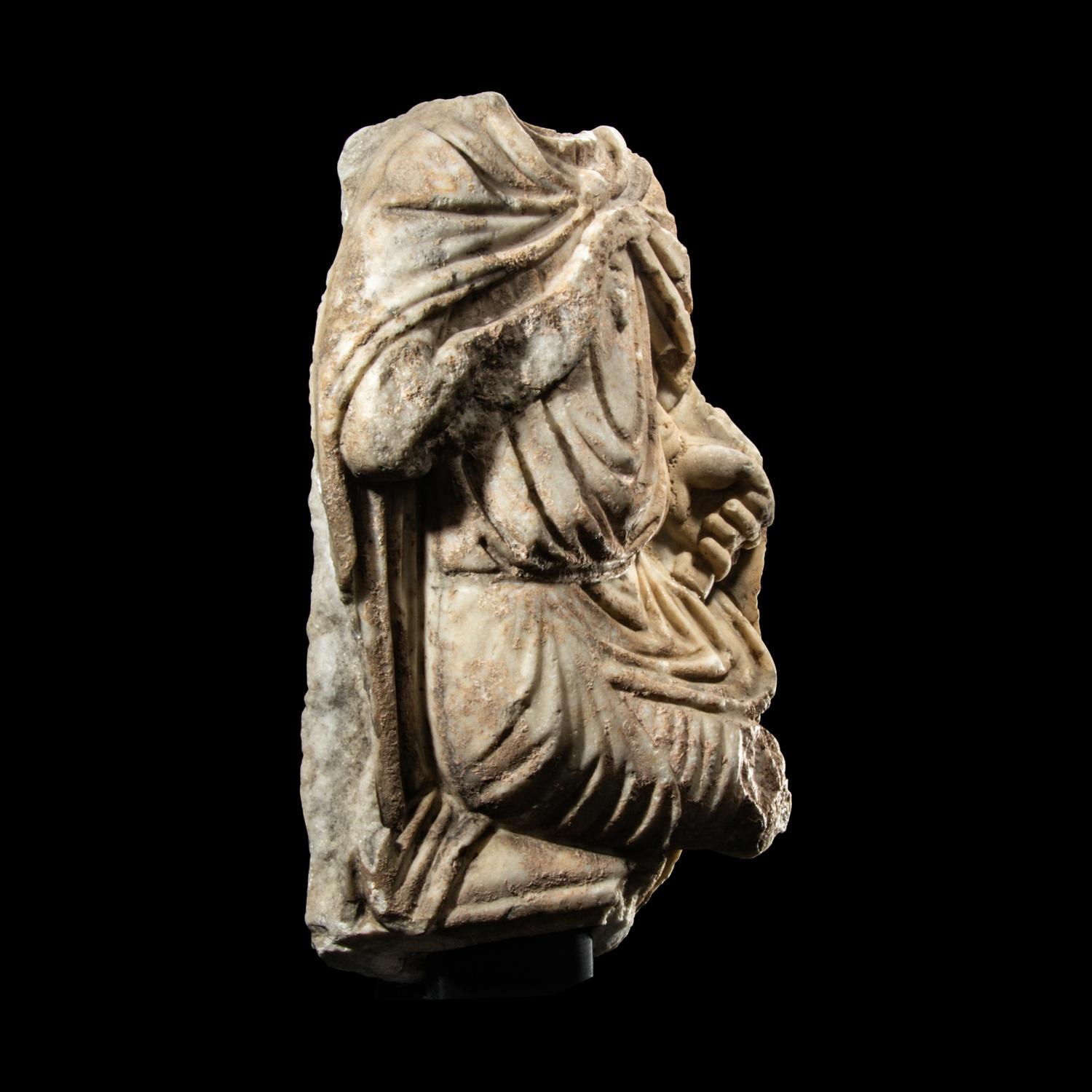 A Roman Marble Fragment of a Seated Offical