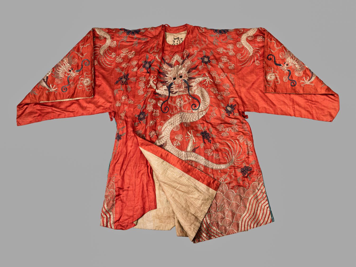 A Chinese Orange Ground Embroidered Silk Theatrical Dragon Robe
