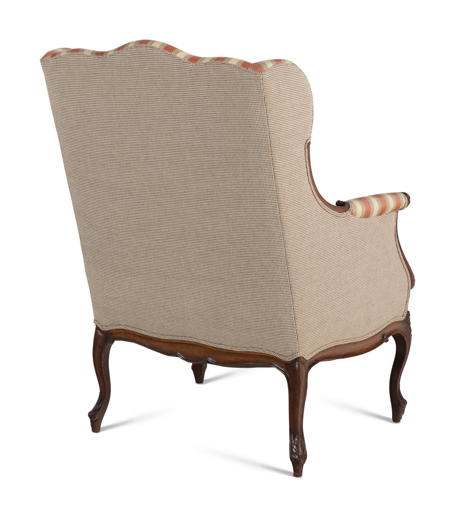 A Pair of Louis XV Style Carved Wingback Armchairs