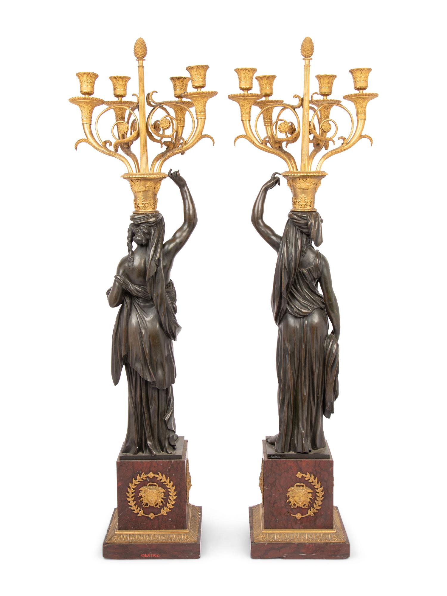 A Pair of Empire Style Gilt and Patinated Bronze and Marble Figural Four-Light Candelabra
