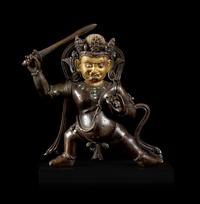 A Sino-Tibetan Parcel-Gilt Bronze Figure of Jambhala