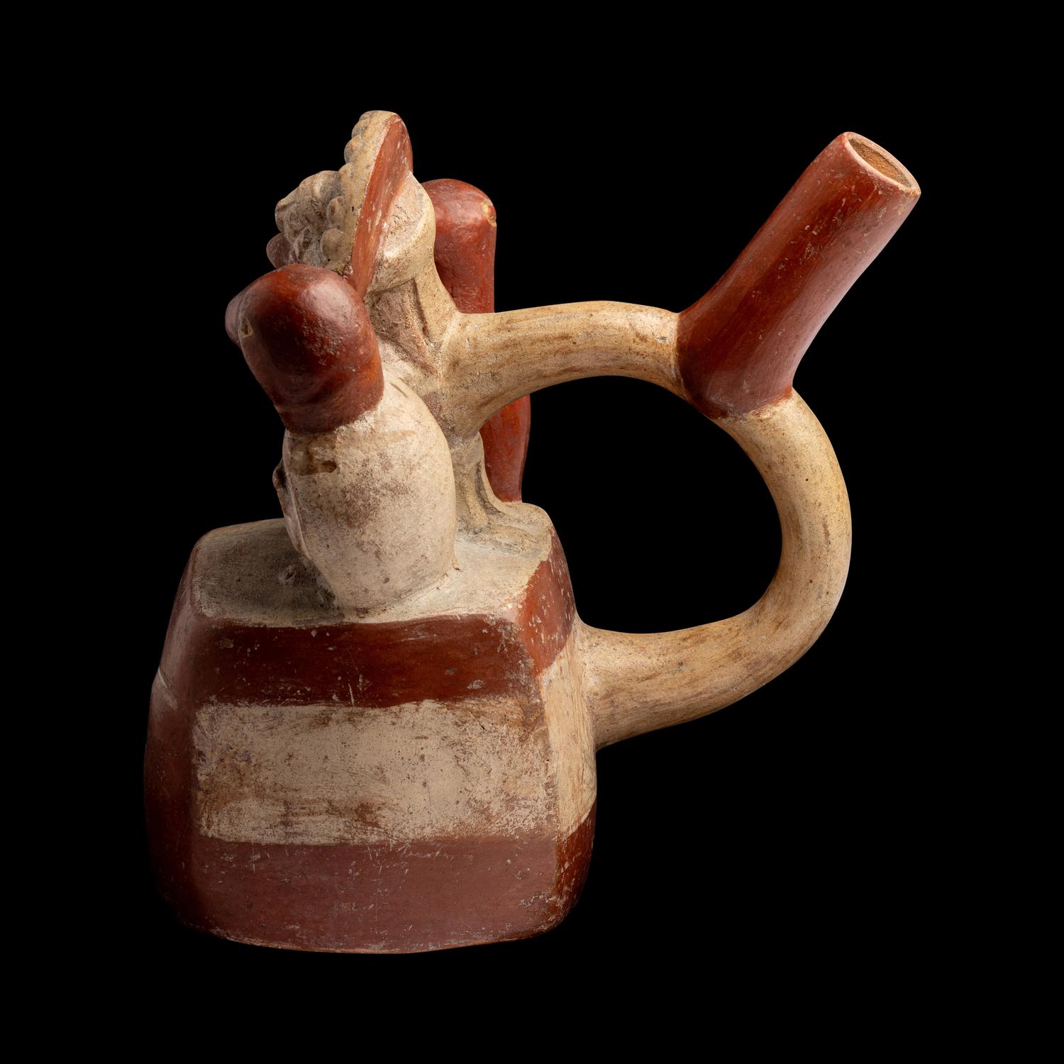 A Moche Stirrup Vessel in the Form of a Shaman with Two Anthropomorphic Figures