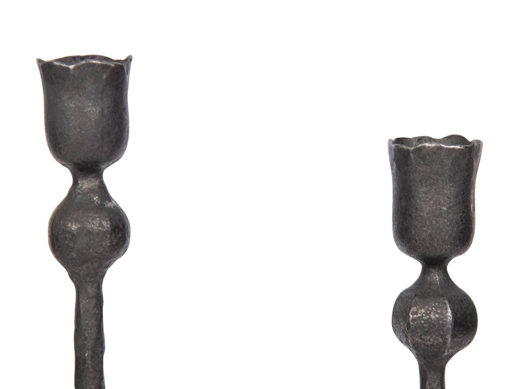 A Set of Eight Wrought Iron Candlesticks