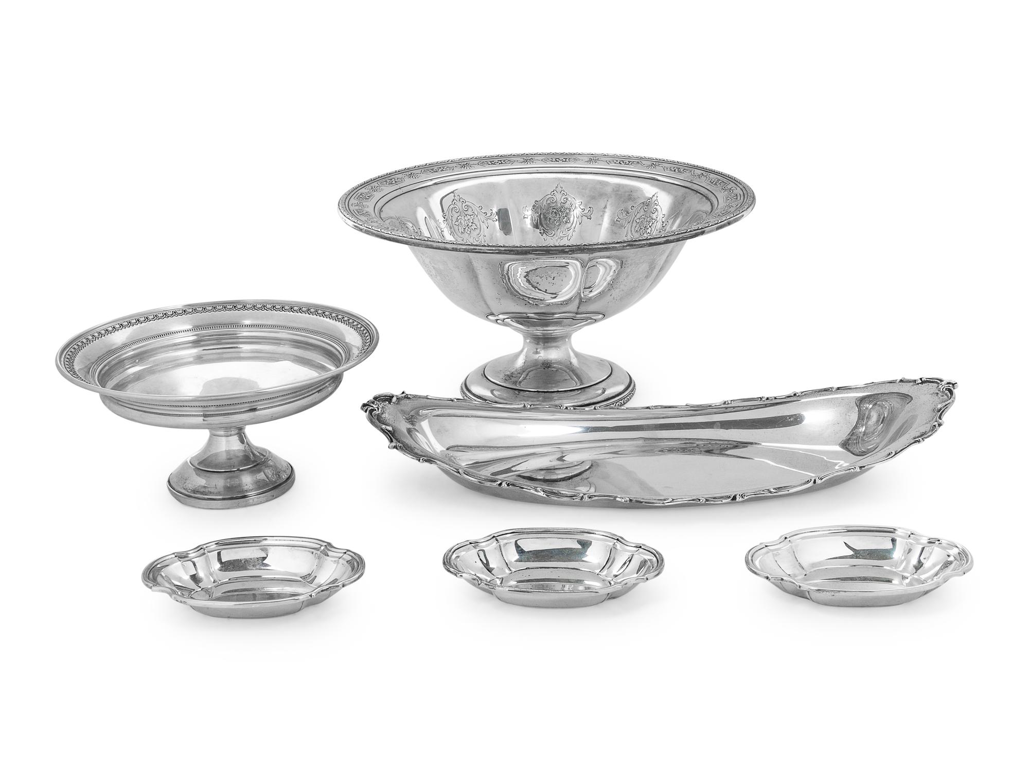 comprising an oval serving dish, three nut dishes, a compote, and a weighted compote.