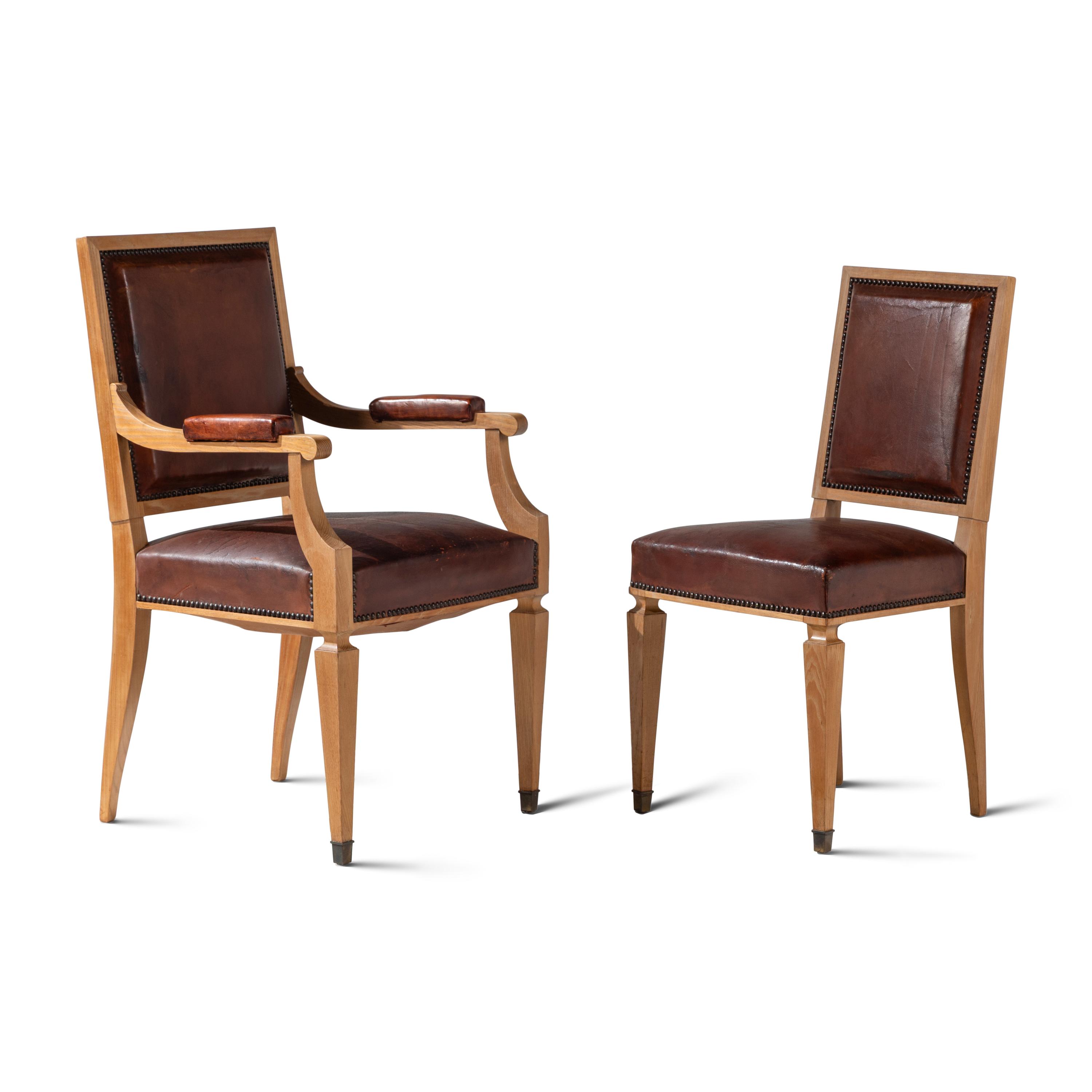 A Set of Twelve Leather-Upholstered Cerused Oak Dining Chairs