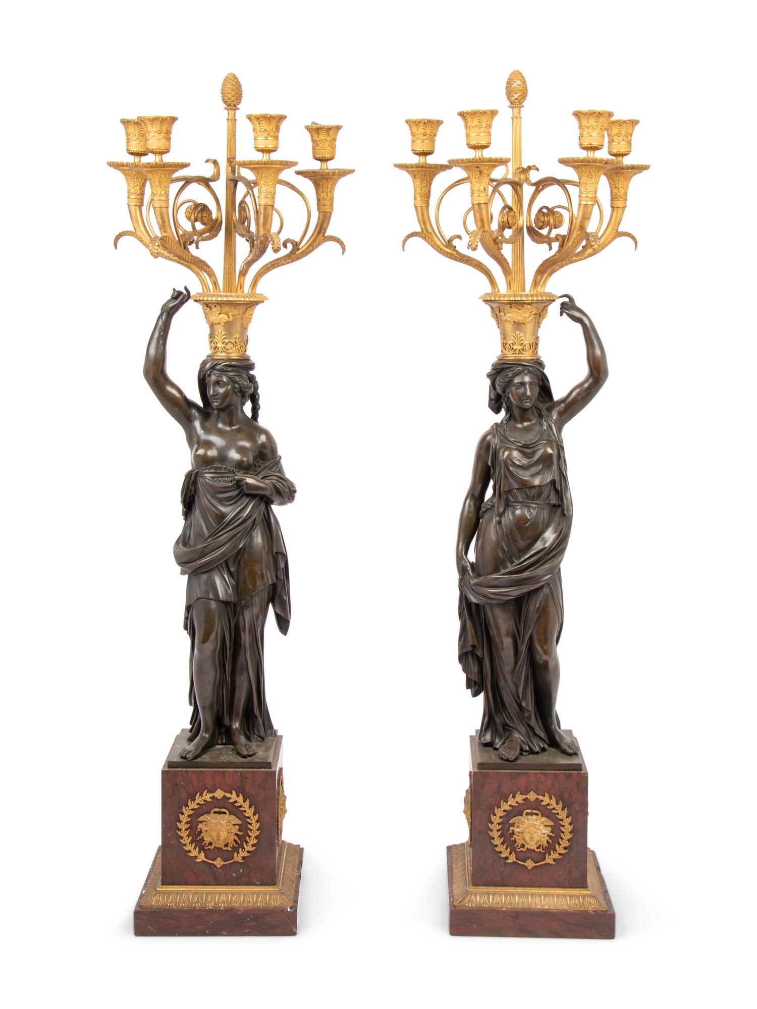 A Pair of Empire Style Gilt and Patinated Bronze and Marble Figural Four-Light Candelabra