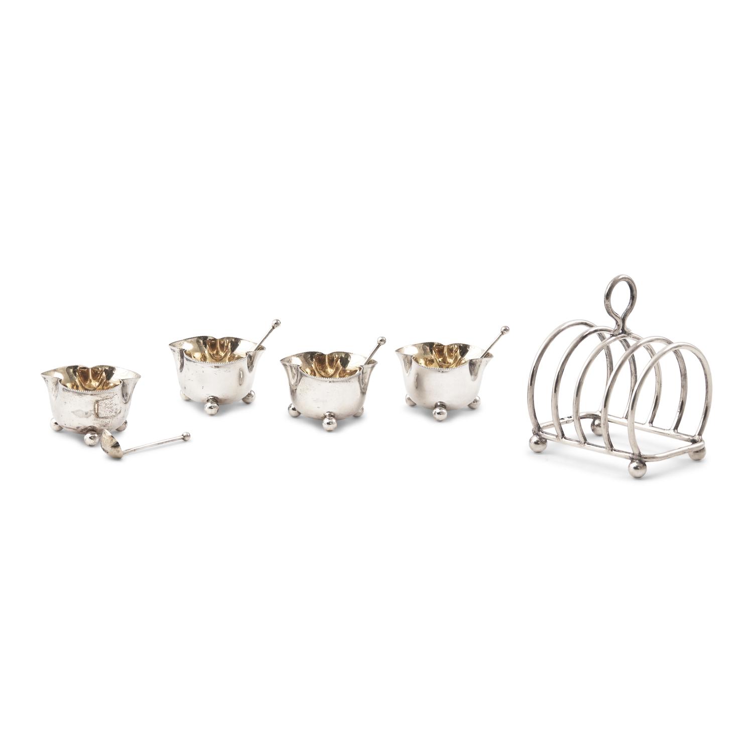 A Set of Four English Silver Trefoil Salt Cellars and a Silver Toast Rack