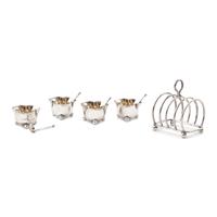 A Set of Four English Silver Trefoil Salt Cellars and a Silver Toast Rack