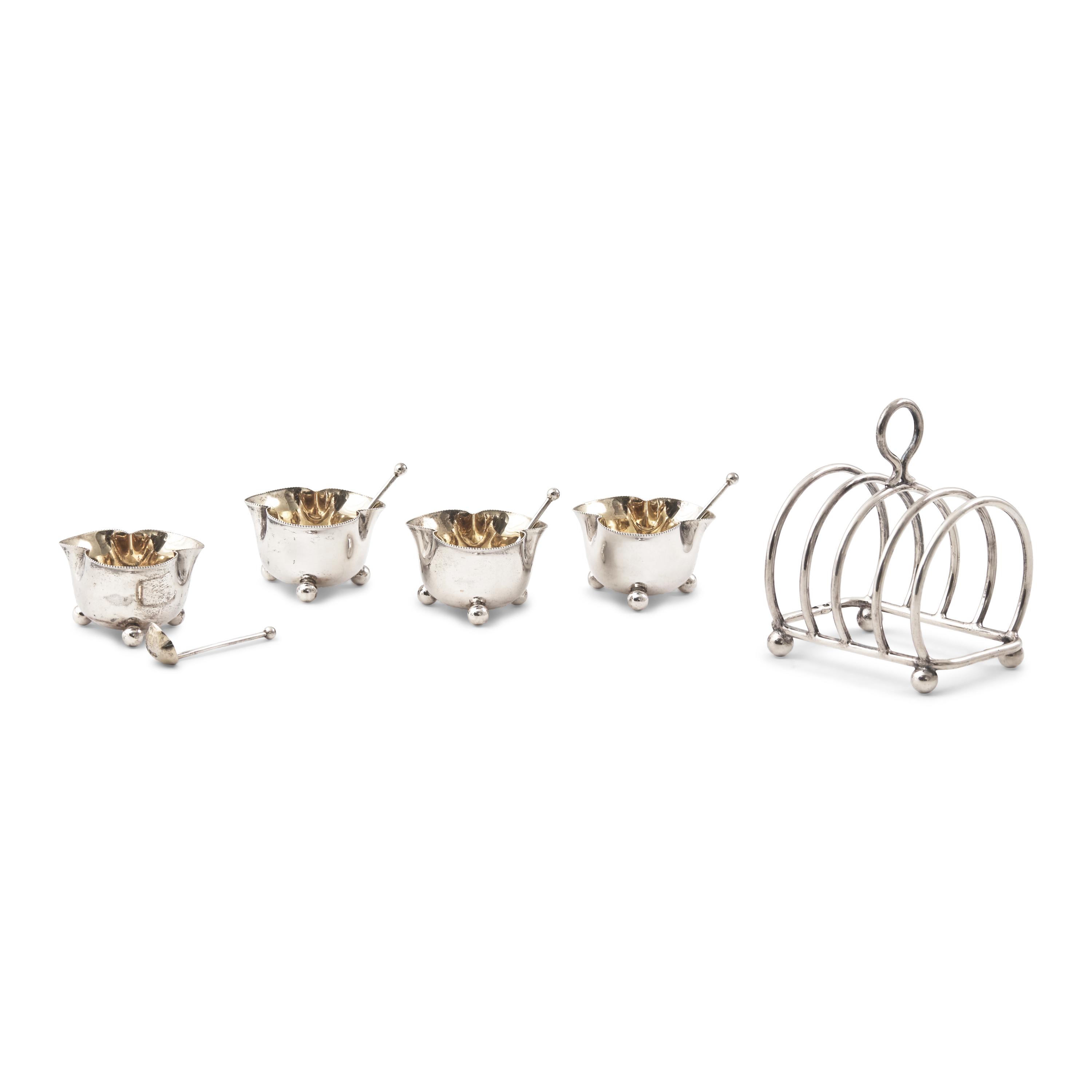 A Set of Four English Silver Trefoil Salt Cellars and a Silver Toast Rack