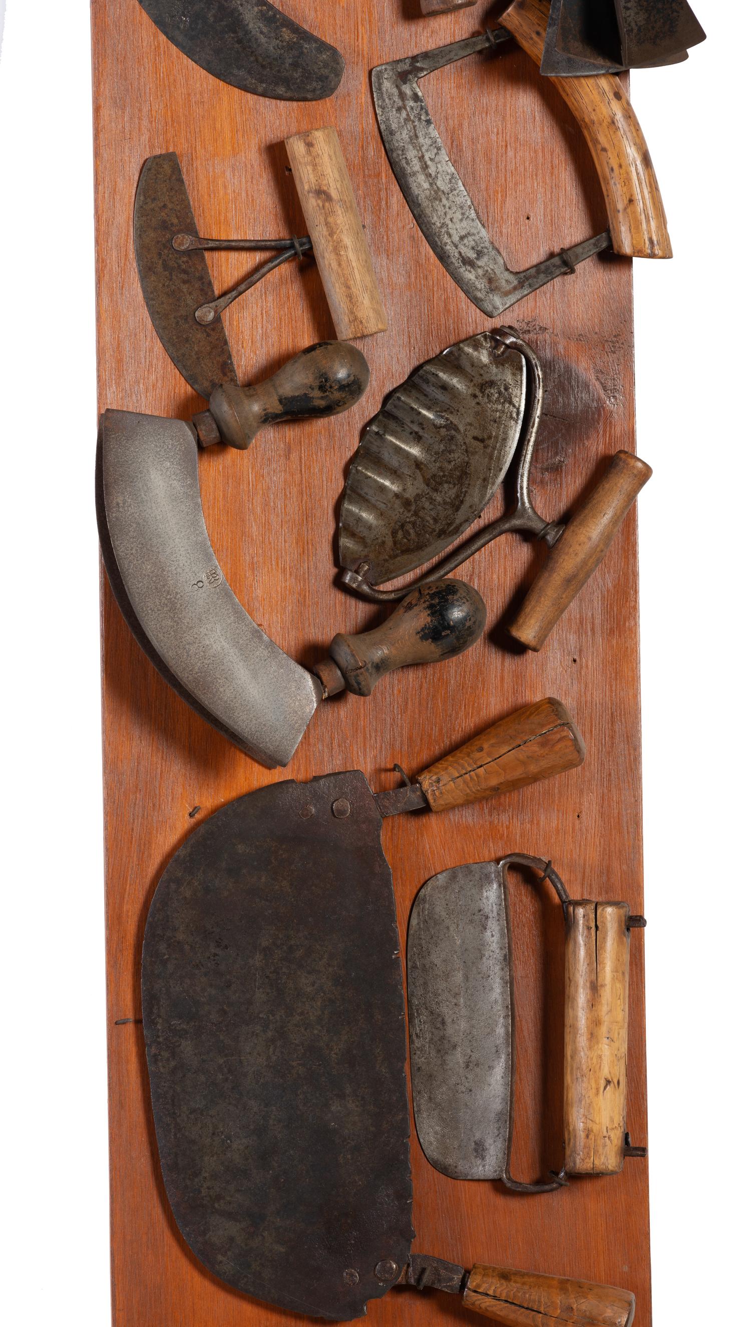 A Collection of Wrought Iron Kitchen Tools Mounted to Panel