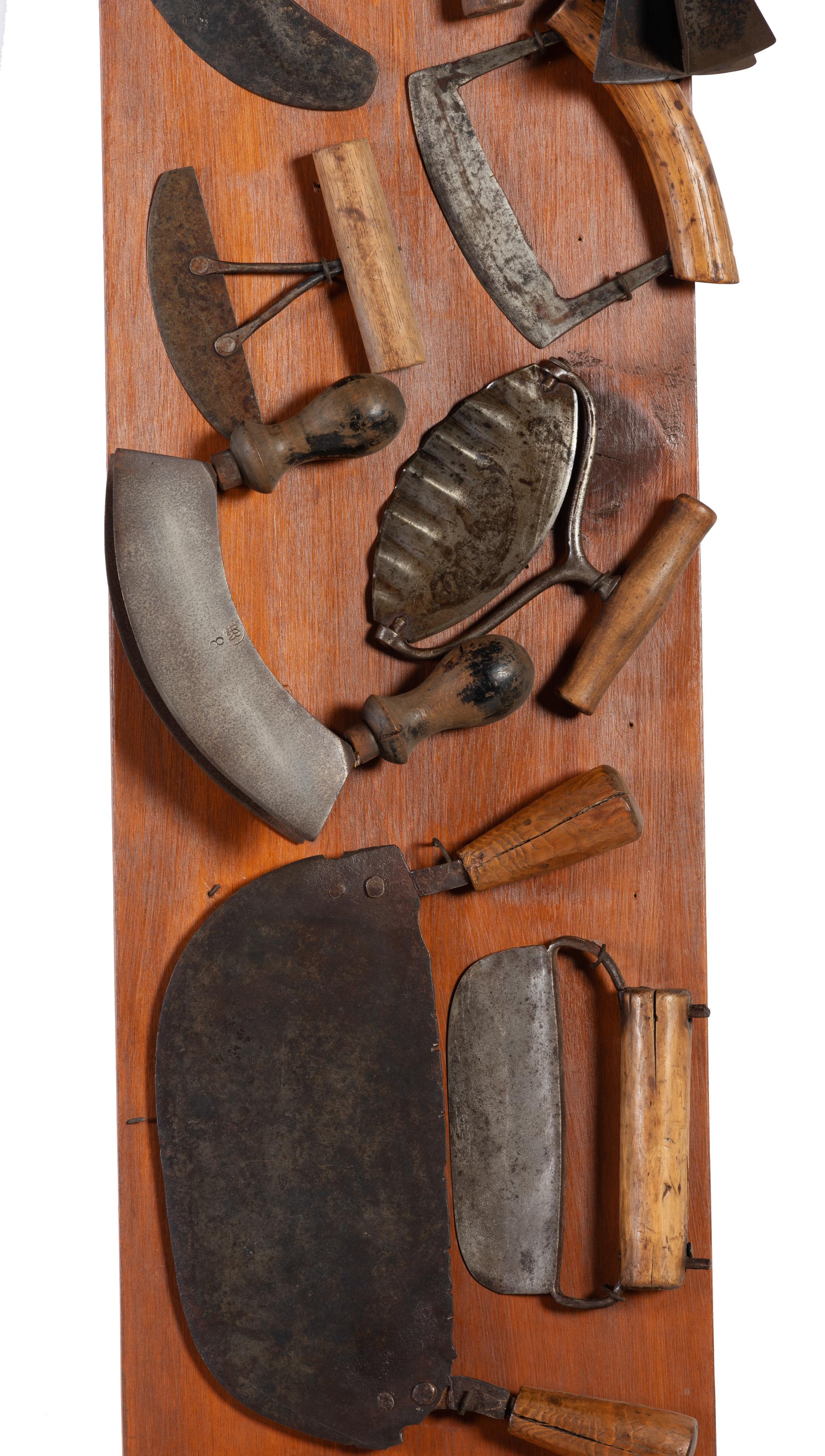 A Collection of Wrought Iron Kitchen Tools Mounted to Panel