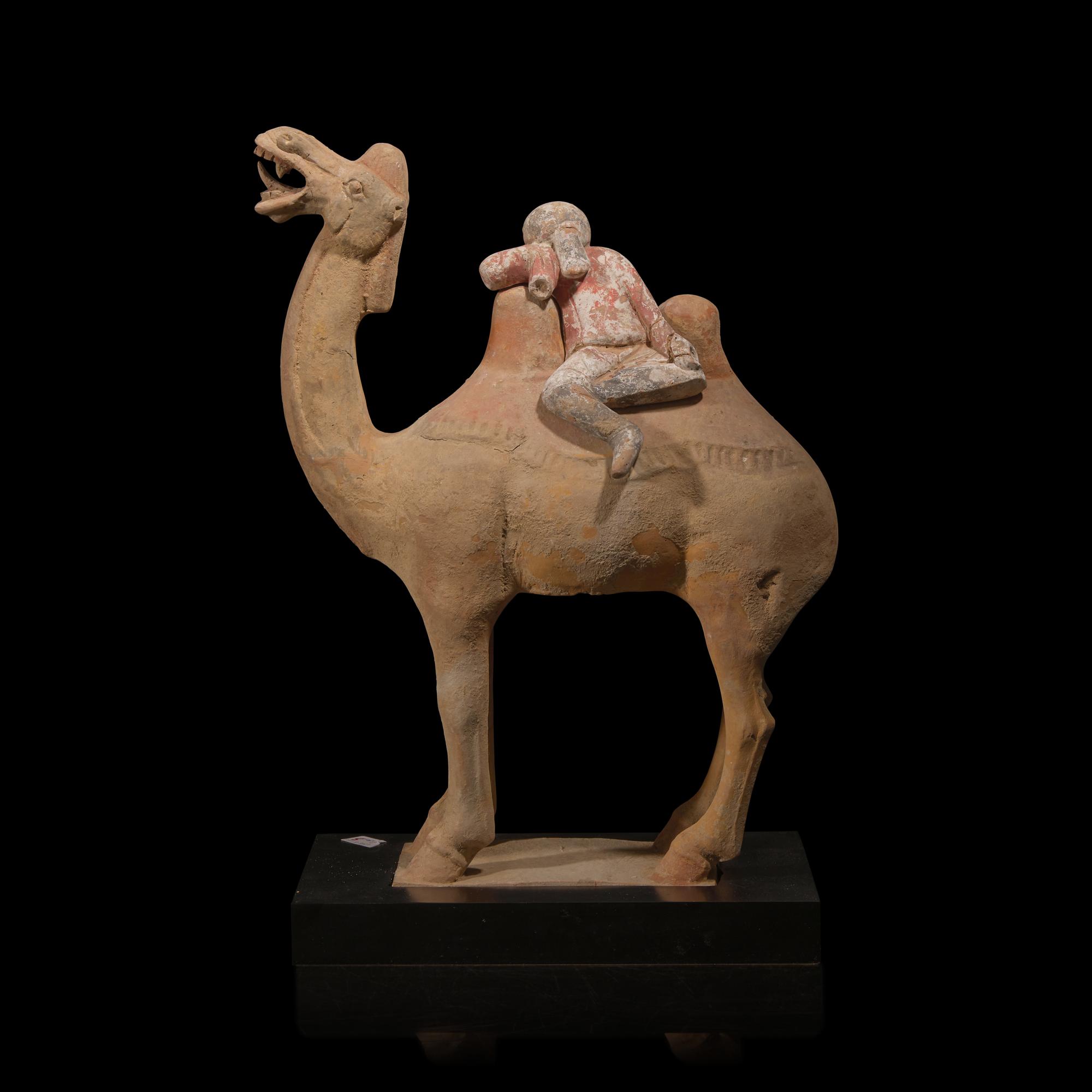 A Chinese Painted Pottery Figural Group of a Camel and a Rider, Possibly Tang Dynasty — 或為唐 陶加彩駱駝俑