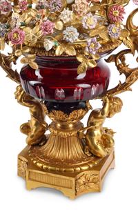 A Louis XV Style Red Cut Glass, Gilt Bronze and Porcelain Clock