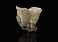 A small Chinese carved greyish-celadon and brown jade coupe, Qing dynasty or earlier 青灰玉小爵杯 清或更早