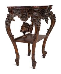 A Renaissance Revival Carved Walnut Serpentine Top Console Table