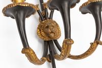 A Pair of Empire Style Gilt and Patinated Bronze Three-Light Sconces