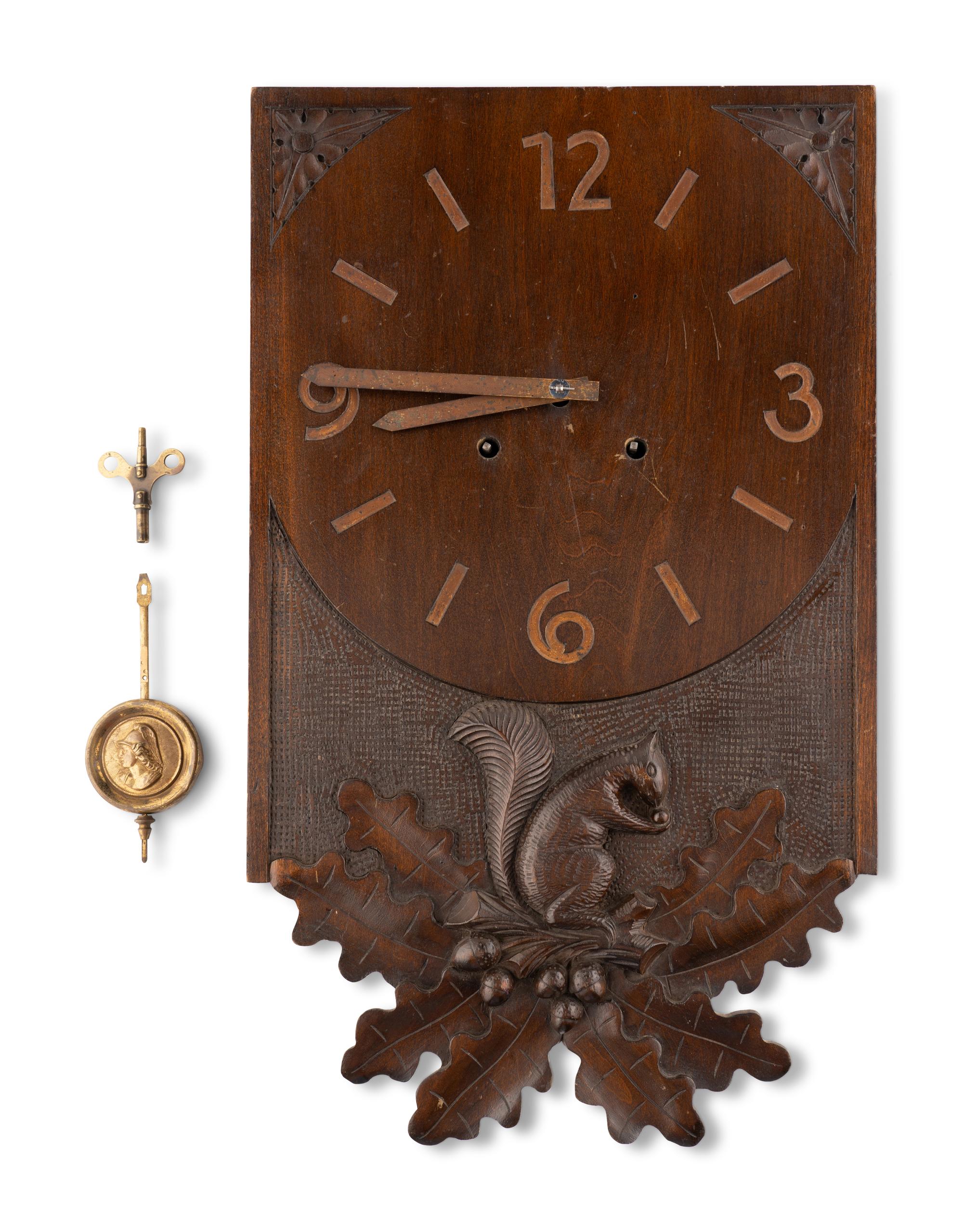 A Swiss "Black Forest" Carved Walnut Wall Clock