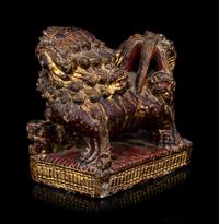 A Chinese Gilt and Red Painted Stone Fu Lion