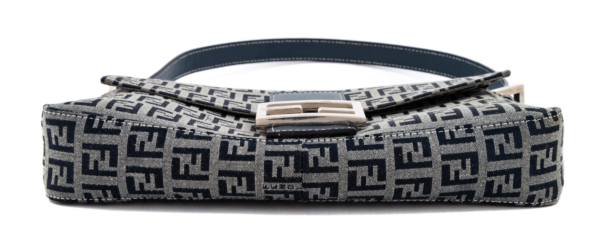A Fendi Navy Monogram Canvas Zucca Baguette, 5" H x 10.25" W x 1.75" D; Strap drop: 6.5"- 9.5".