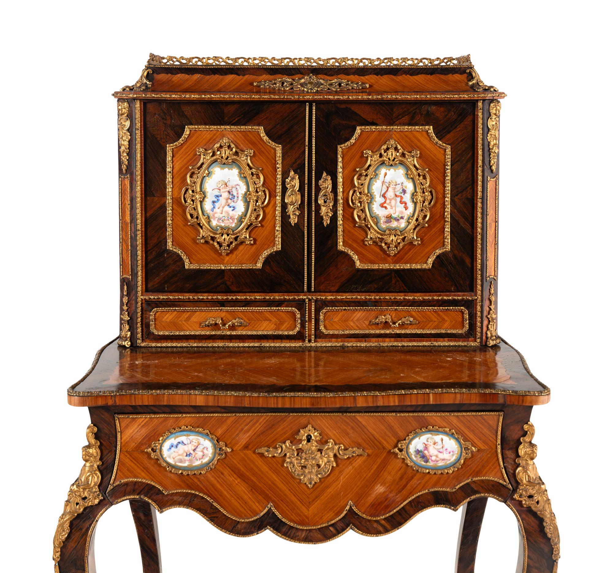 A Napoleon III Gilt Bronze and Porcelain Mounted Kingwood and Rosewood Bonheur du Jour