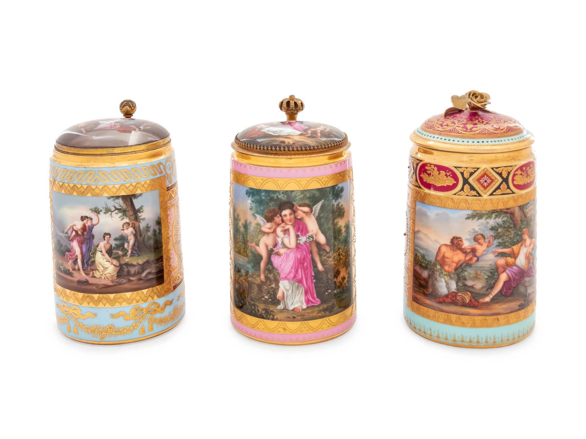 Three Vienna Painted and Parcel Gilt Porcelain Tankards