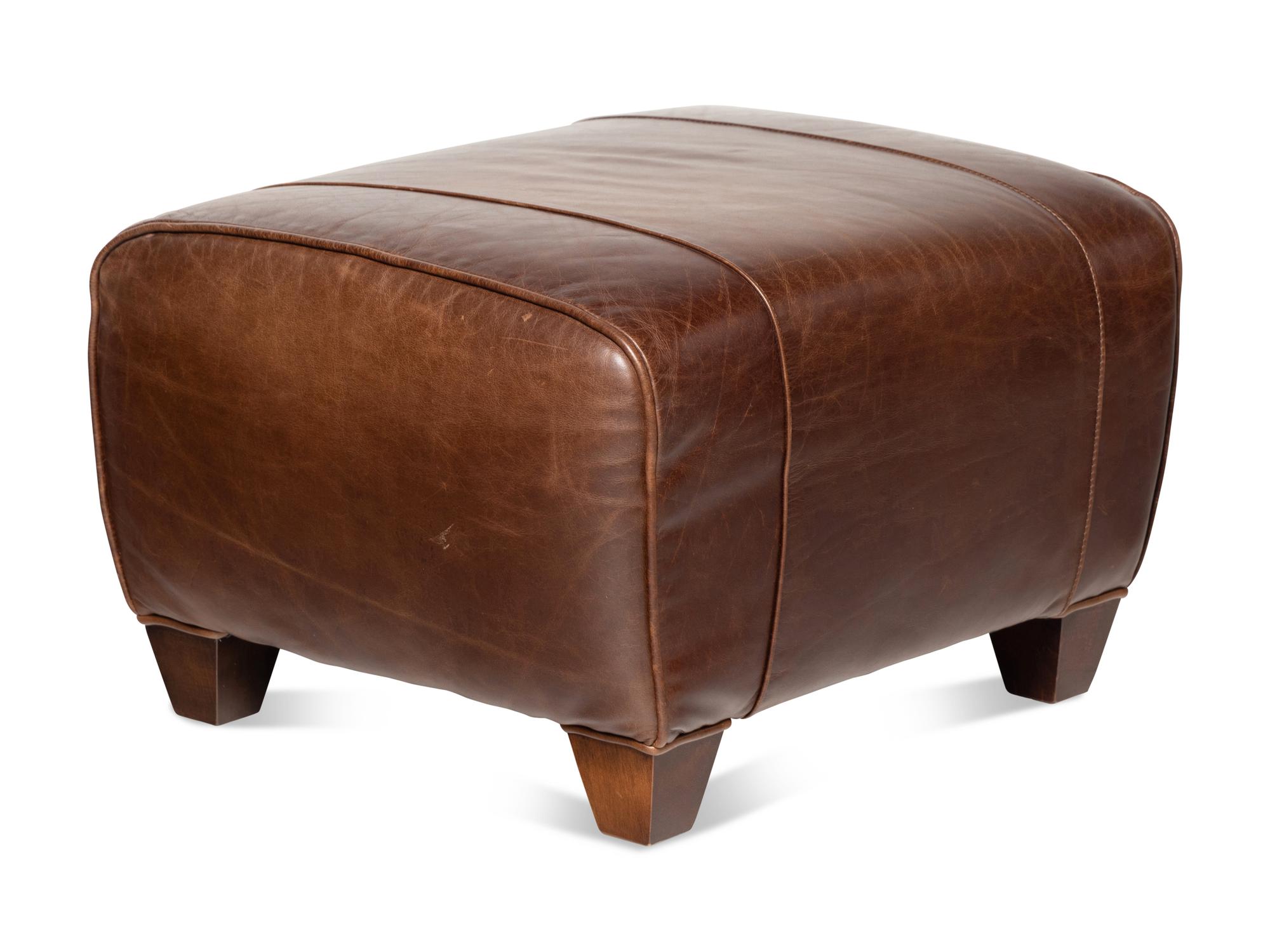 A Contemporary Leather-Upholstered Lounge Chair and Ottoman