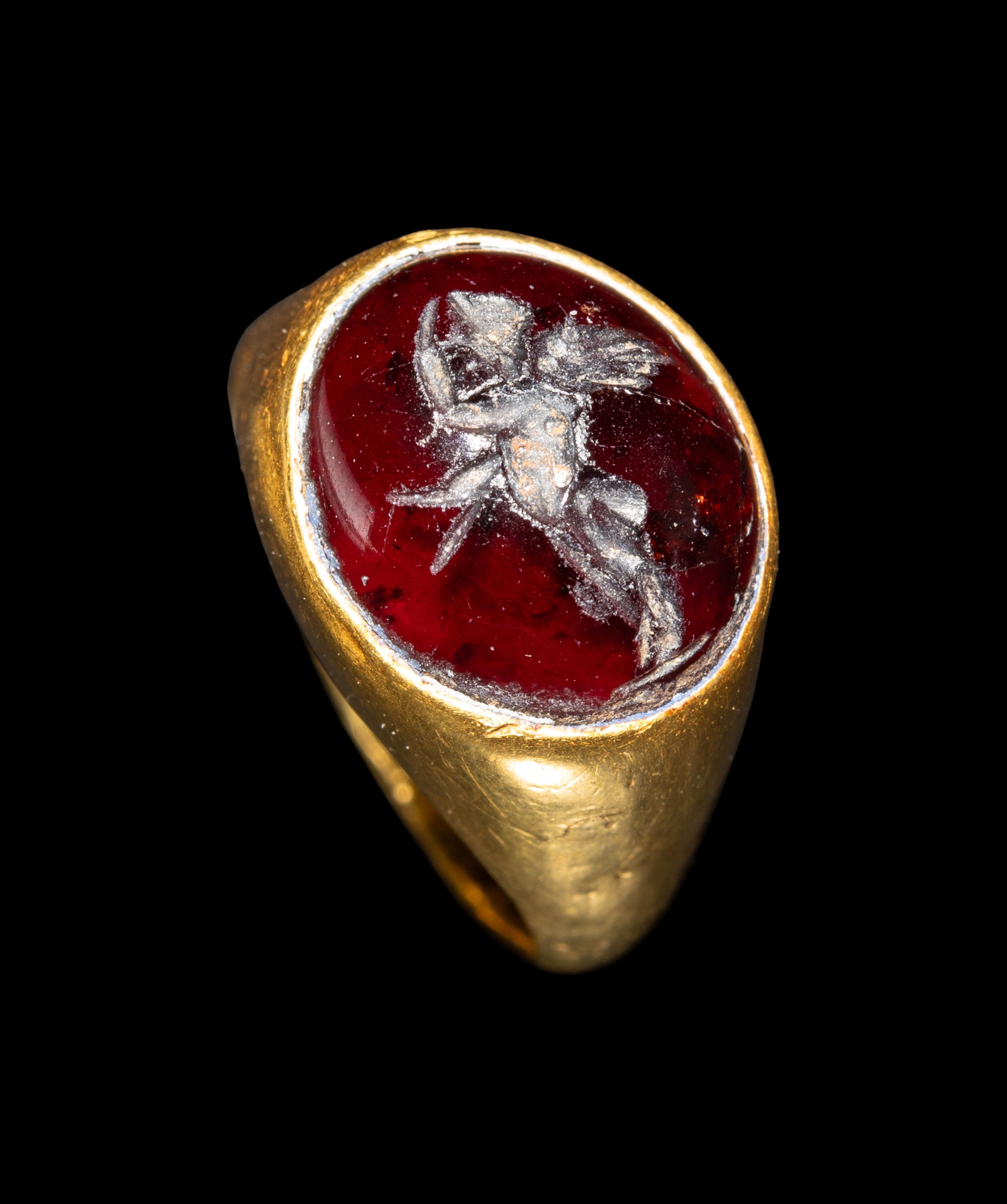 A Hellenistic Gold and Garnet Finger Ring with the God Eros