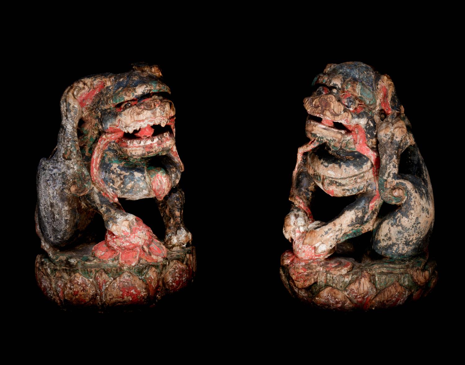 A Pair of Chinese Polychrome Painted Wood Figures of Fu Lions