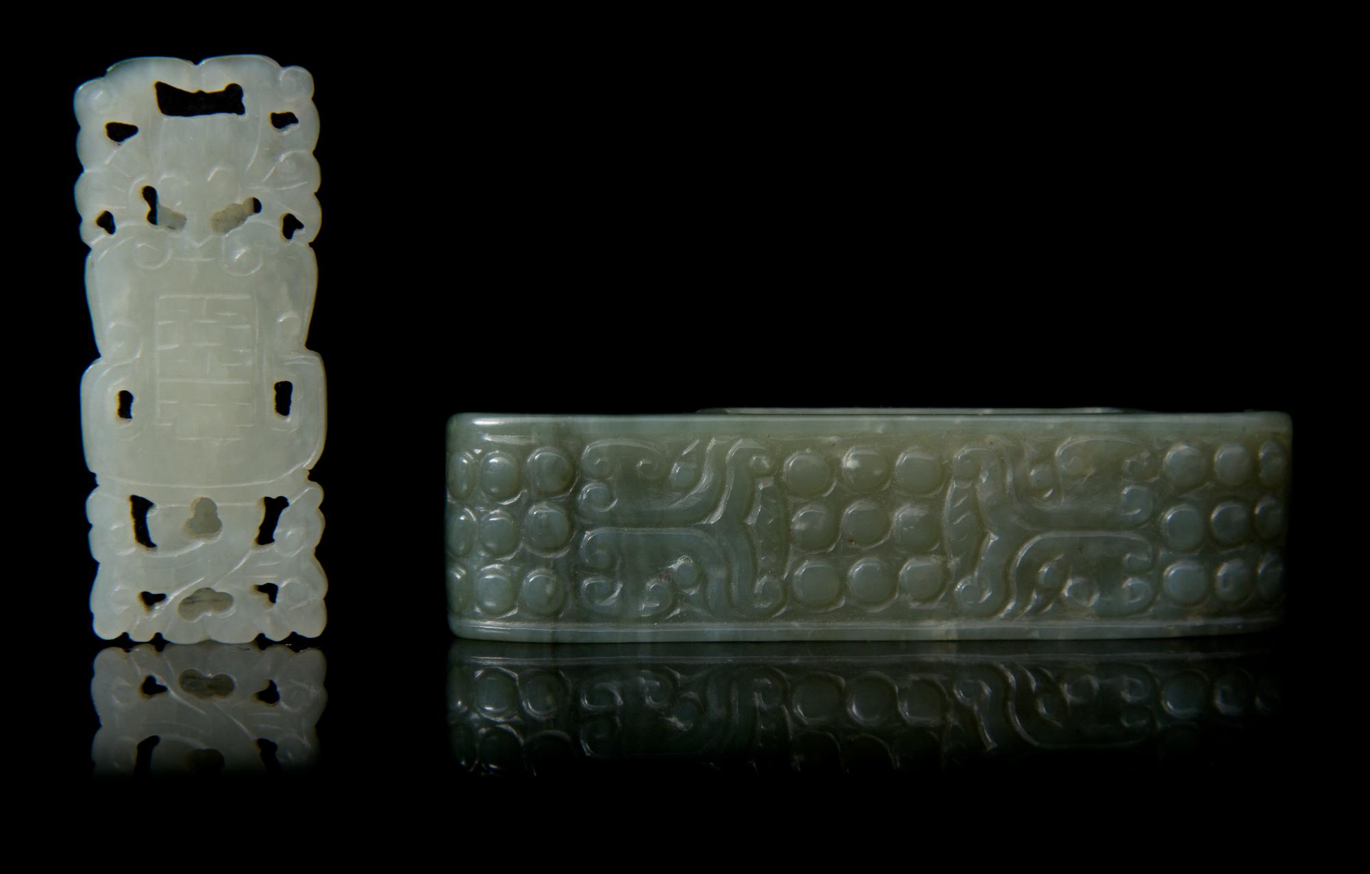 Two Carved Jade Sword Slides Length of larger 2 3/4 inches.