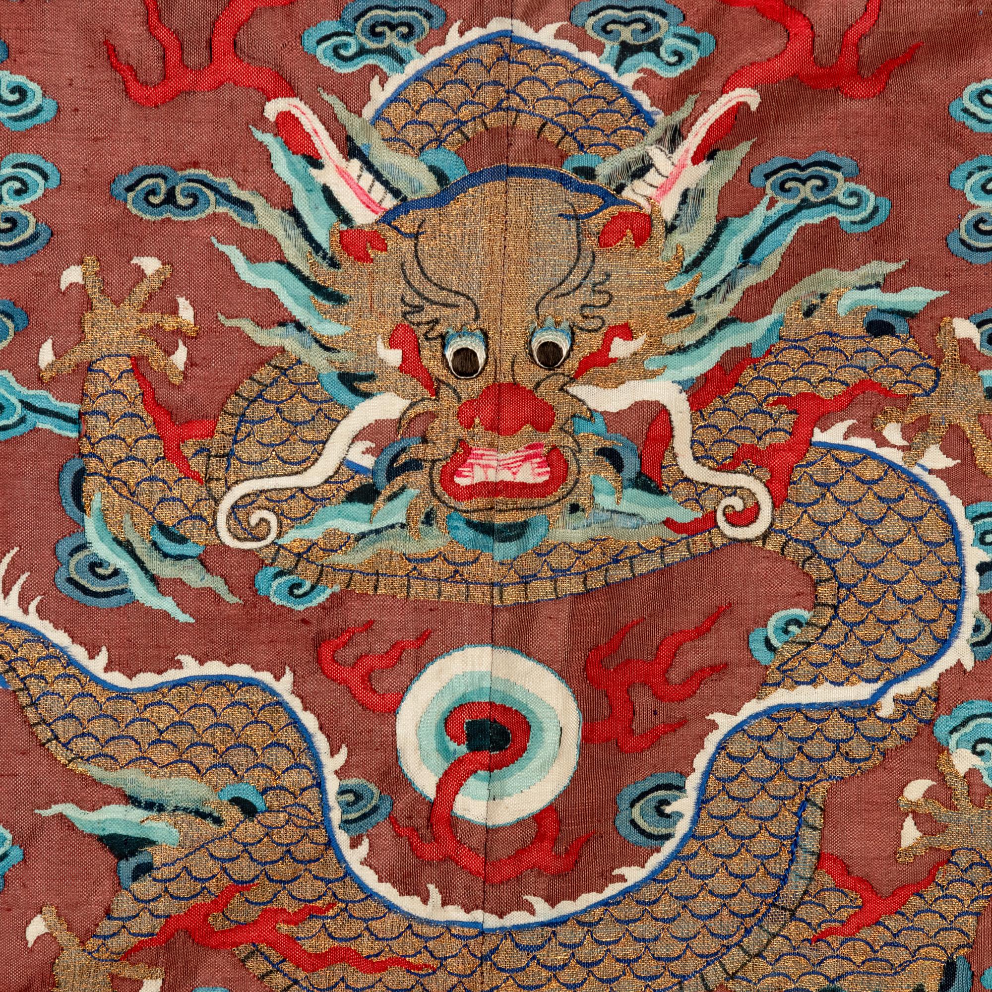 A Chinese Brown Ground Kesi Silk 'Dragon' Robe, Jifu, 19th Century 清晚期 醬地緙絲雲龍紋吉服
